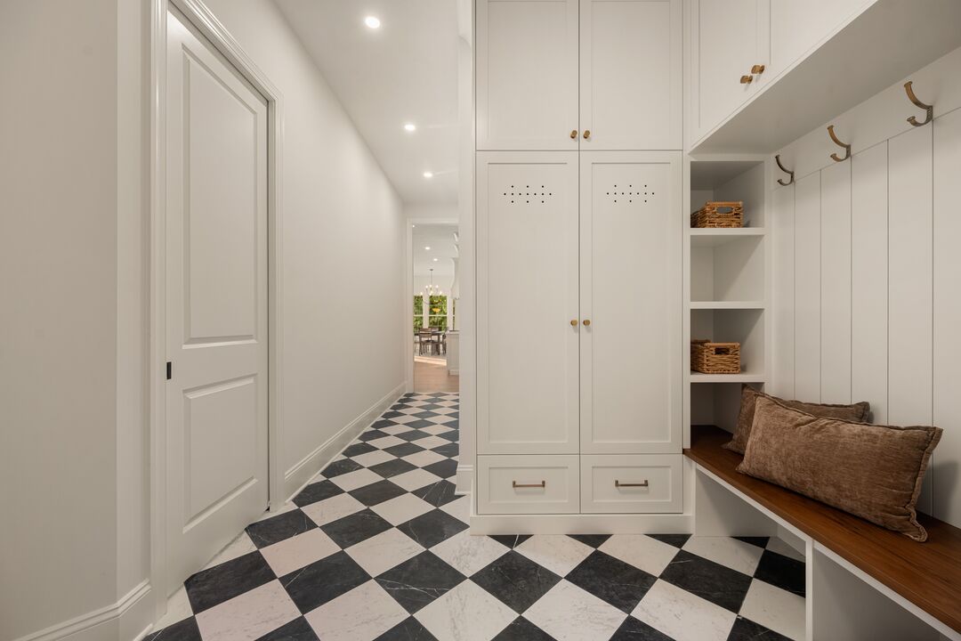 Mudroom in The Cabot Ridge with built-in lockers, a bench and checkerboard tile floor