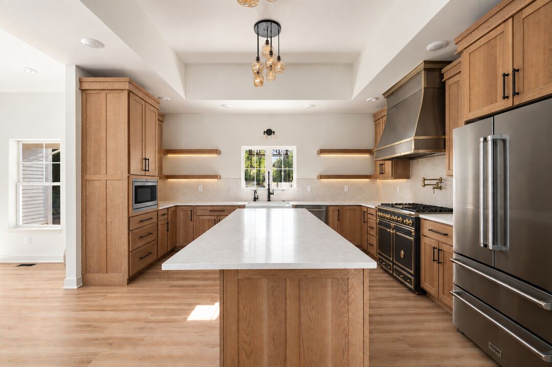Kitchen with wood cabinetry, a center island, open shelving and a stainless range