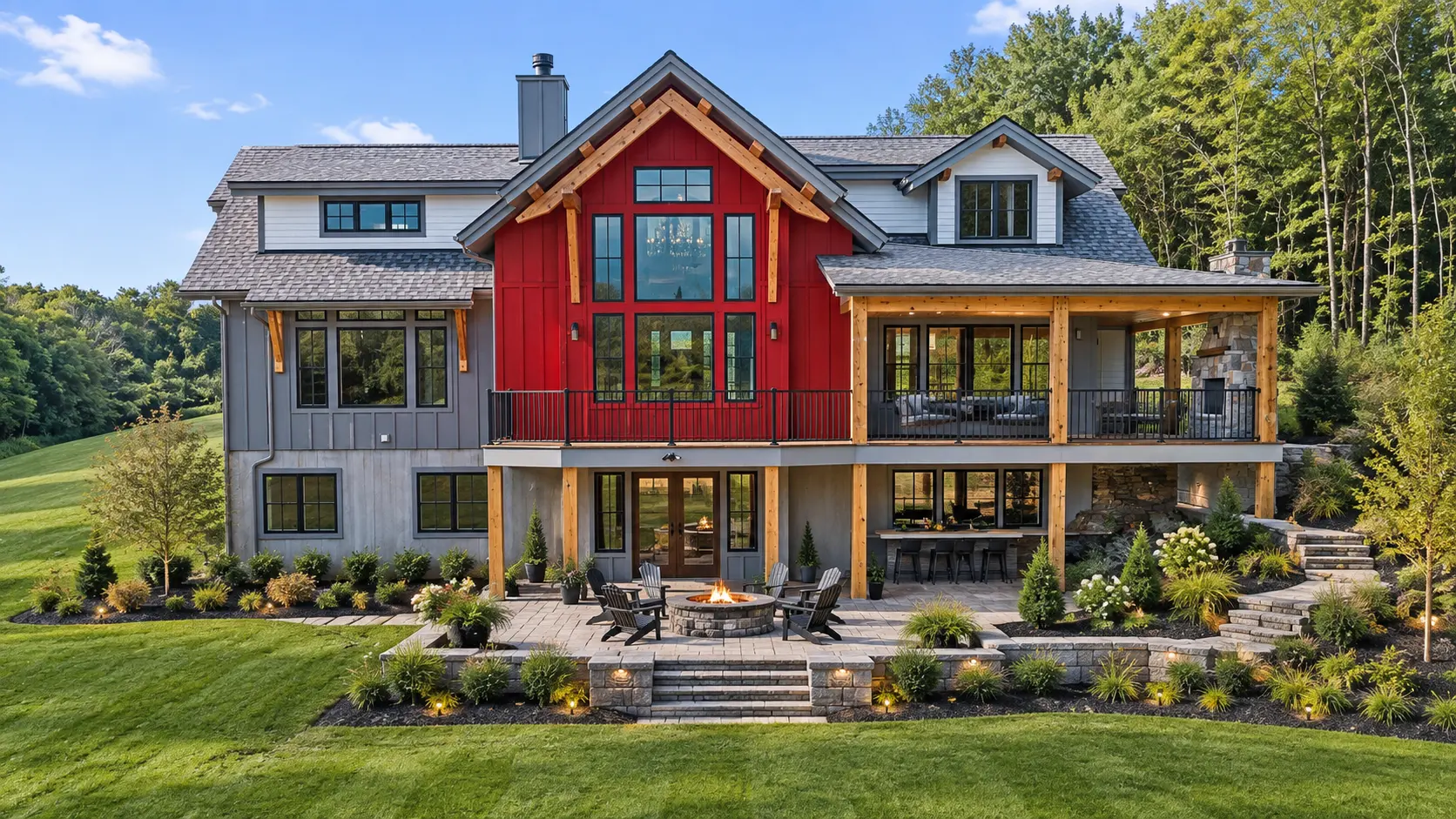 Rear of a Mark Antony custom home with a red timber-frame gable, covered deck and a stone patio with fire pit